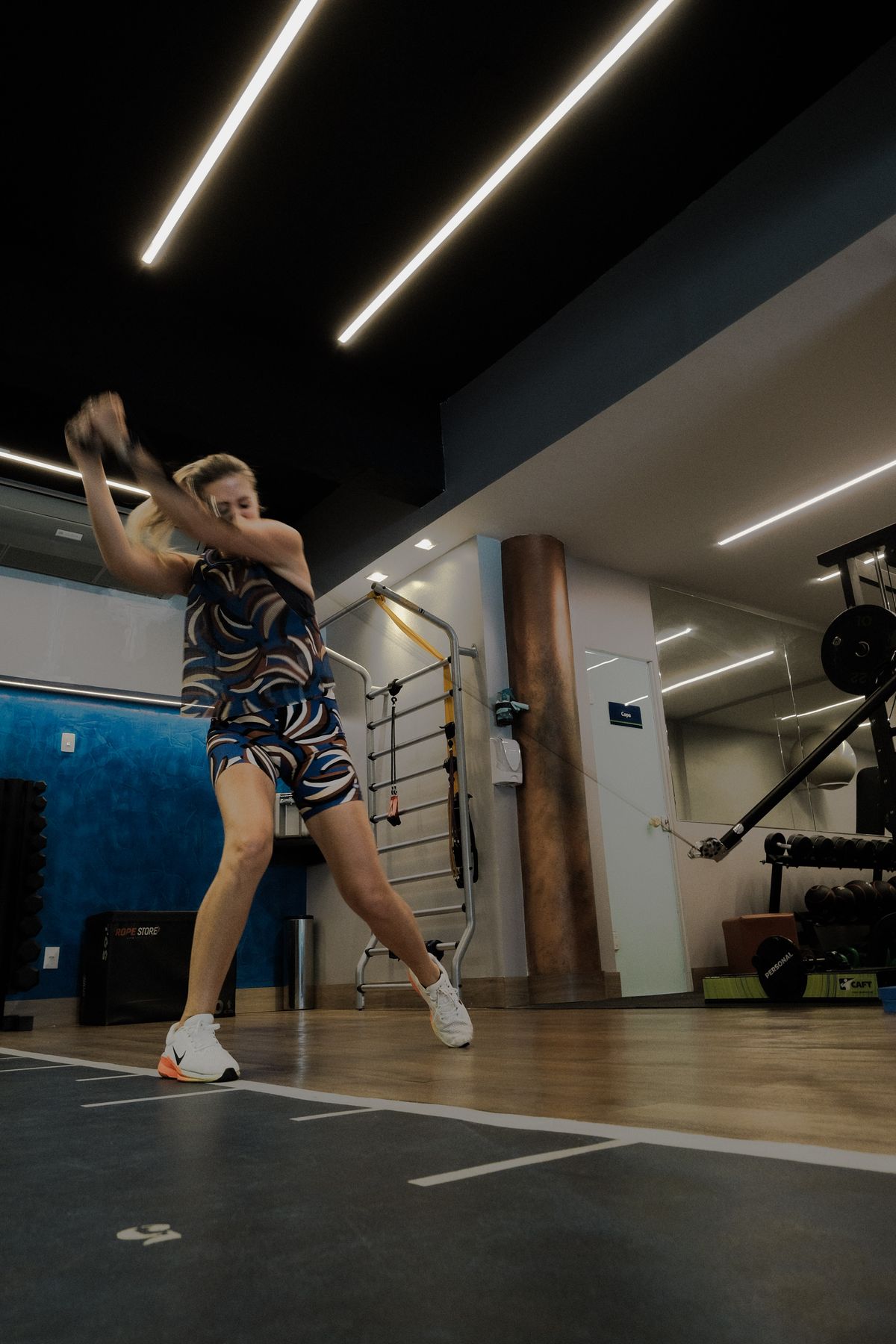 Aluna treinando em máquina de musculação